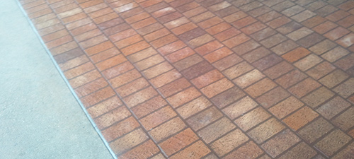 Power washing and surface cleaning and gum removal on a sidewalk in Temple TX, after photo.
